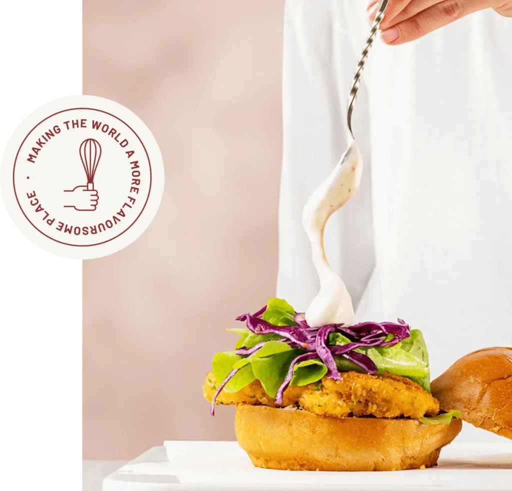 Creamy bespoke sauce drizzle over fresh burger ingredients highlighting Springbrook Foods flavour innovation.